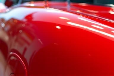 Glossy red sports car after detailing.