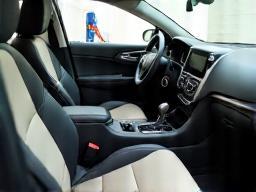 Clean car interior with vacuum cleaner in the background.